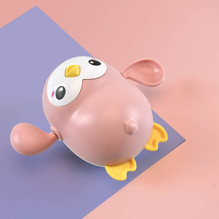 Pink and yellow cartoon-like object on a two-tone purple and pink background.