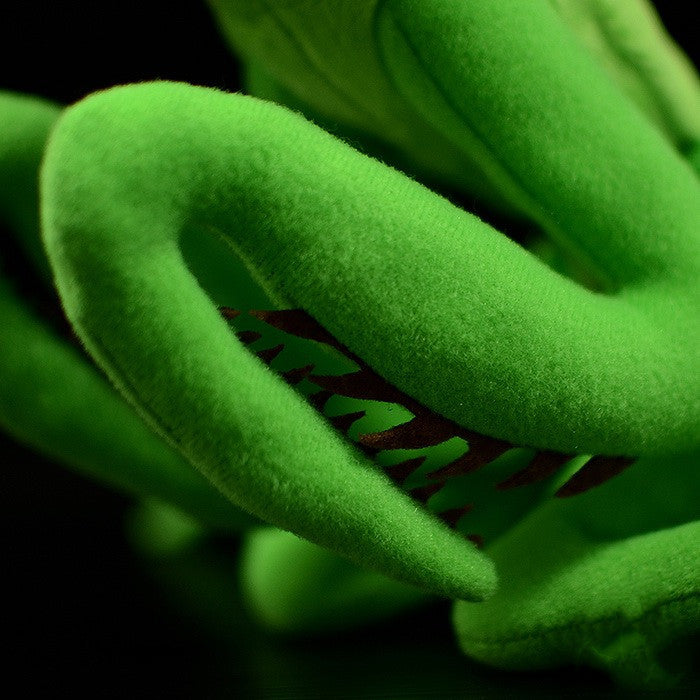 Close-up of green arms with a textured surface on a black background
