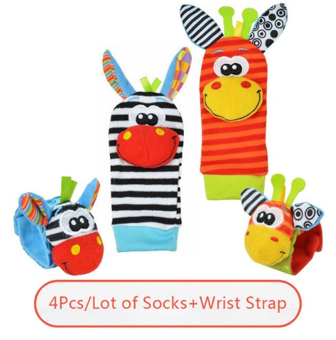 Set of colorful baby socks and wrist straps with animal designs on a white background.