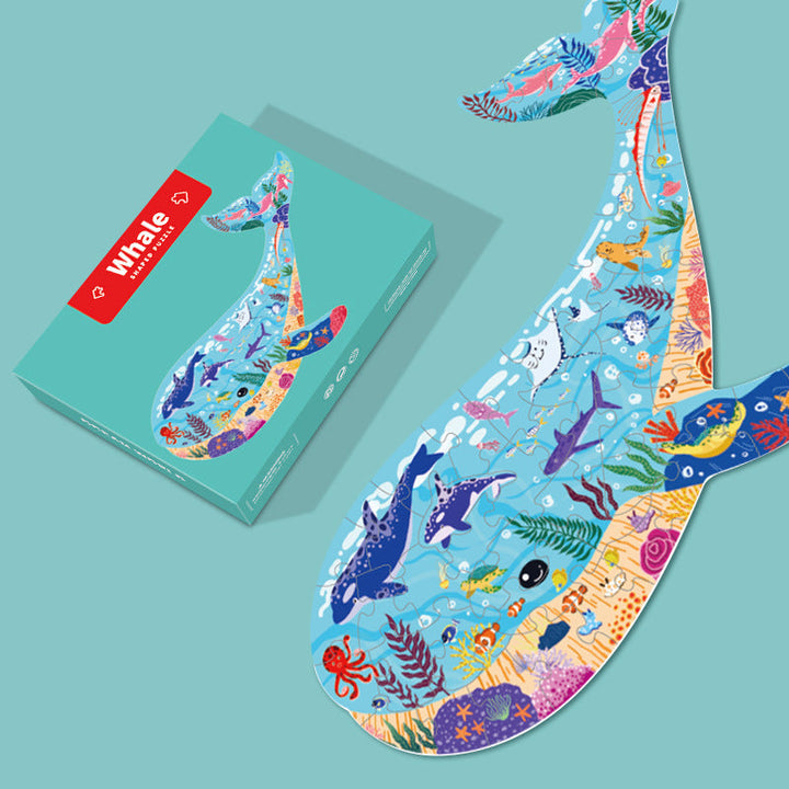 Colorful whale-shaped puzzle with box on a teal background.