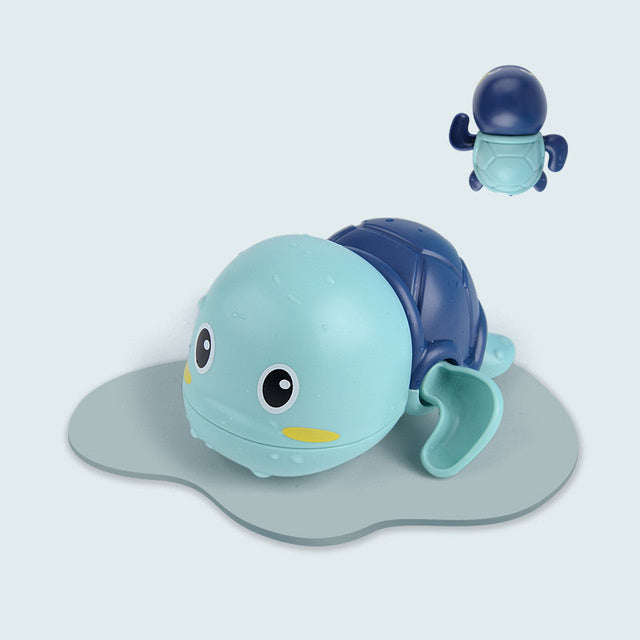 Blue and green turtle bath toy with suction cup on a light gray background.