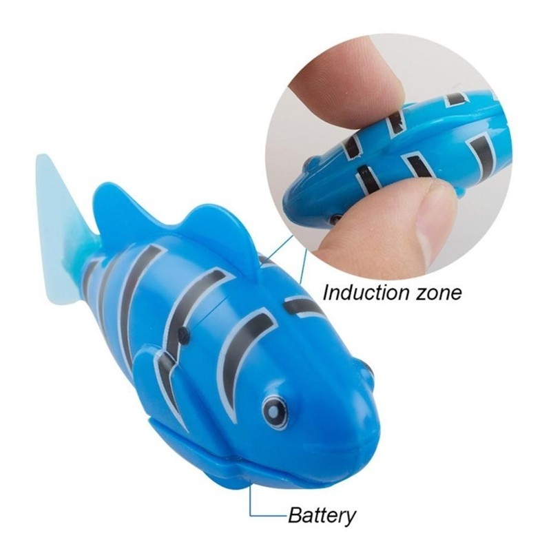 Blue toy shark with an inset showing the induction zone and battery location on a white background.