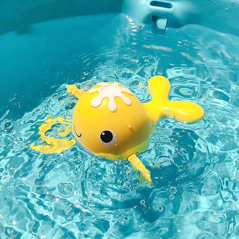 Yellow toy octopus floating in clear blue water.