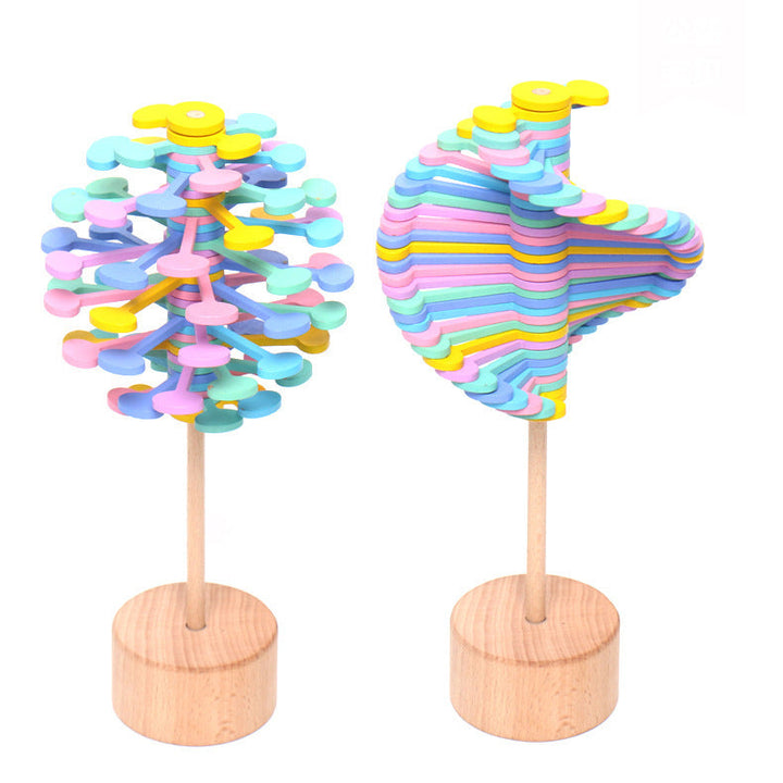 Two colorful tree-shaped objects on wooden stands against a white background.