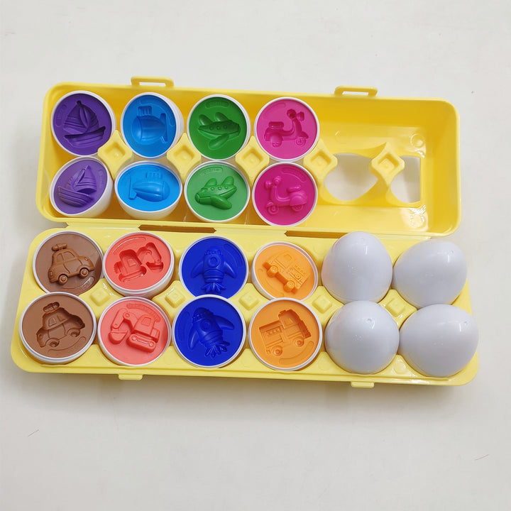 Colorful egg-shaped molds with corresponding stamps on a yellow tray against a white background.