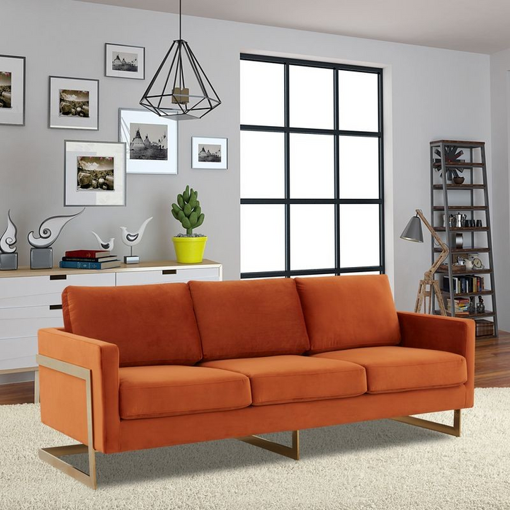 LeisureMod Lincoln Modern Mid-Century Upholstered Velvet Sofa with Gold Frame Orange Marmalade with Background.