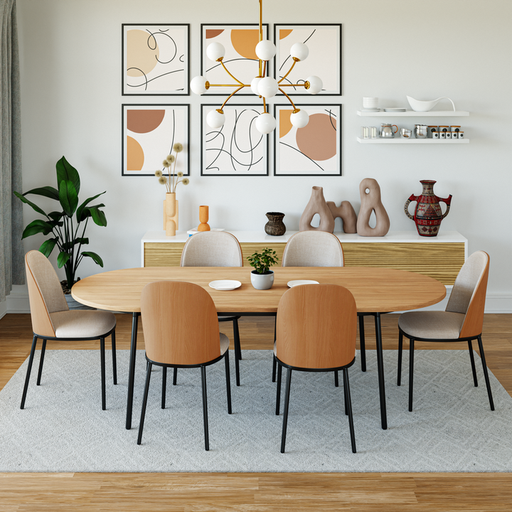 LeisureMod Tule Modern 83" Oval Dining Table with MDF Top and Black Steel Legs in Natural Wood in Room.
