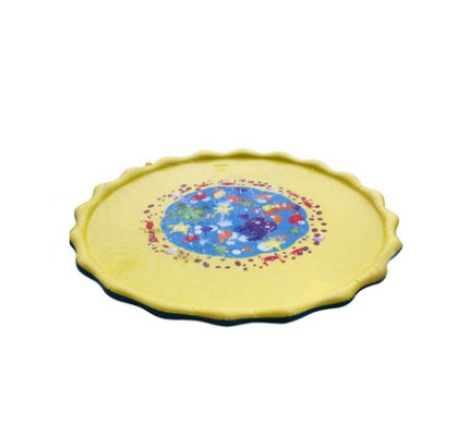 Round yellow mat with colorful design on a white background.