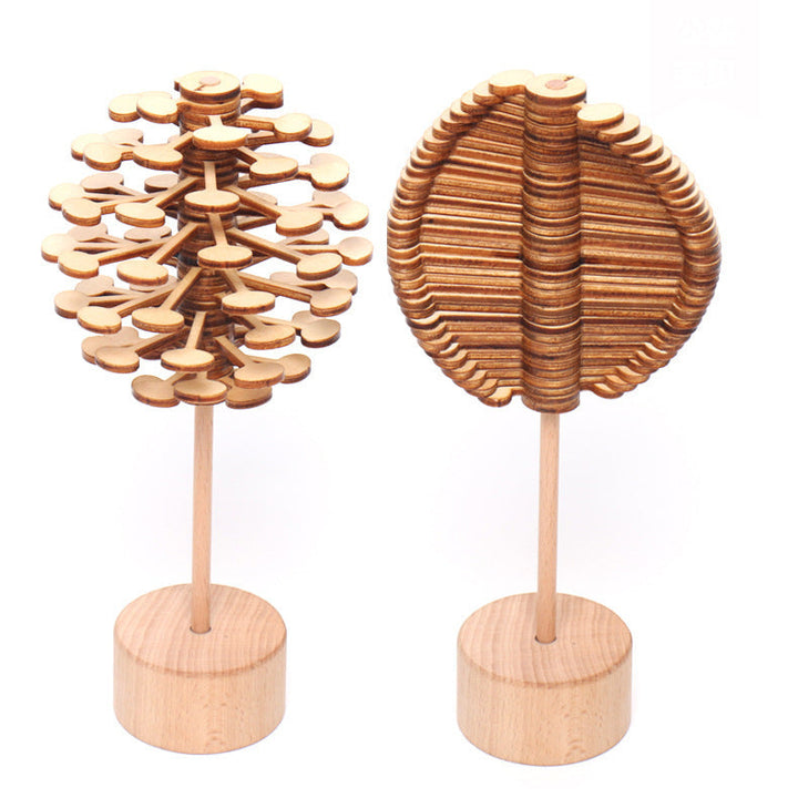 Two wooden tree-shaped objects on stands against a white background.