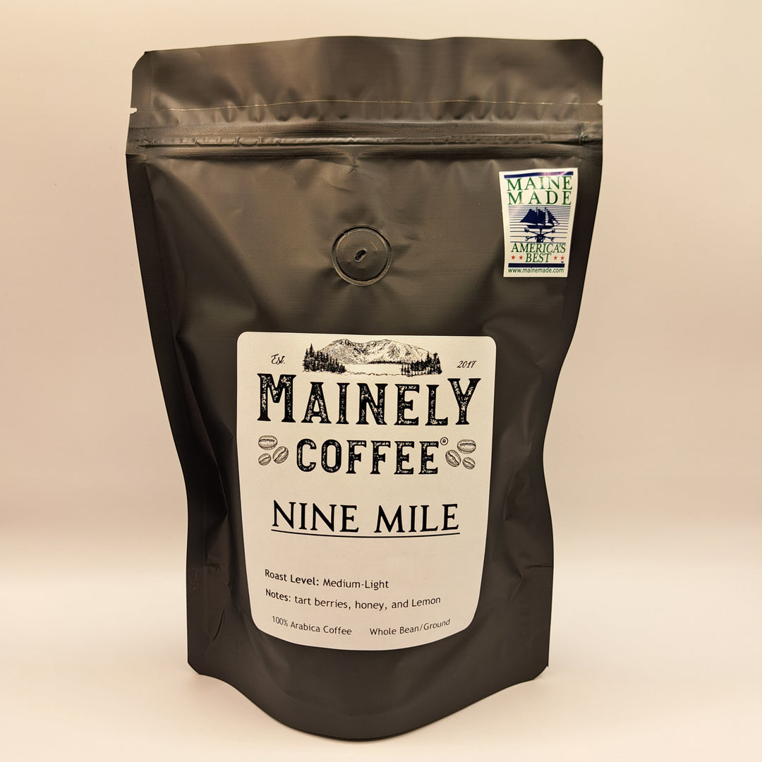 Brown coffee bag with Mainely Coffee Nine Mile label on a beige background