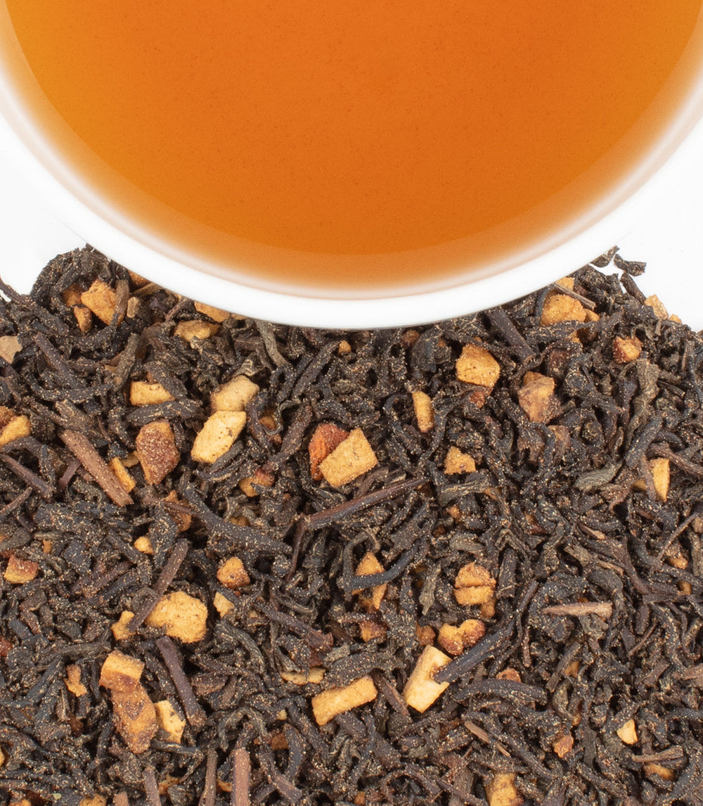 Tea leaves and a cup of tea on a white background
