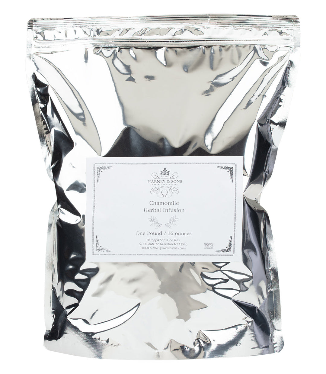 Silver packaging of chamomile herbal infusion with a label on a white background.