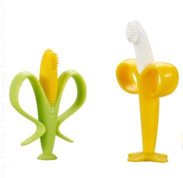 Two baby teethers shaped like a banana and a corn on a white background.