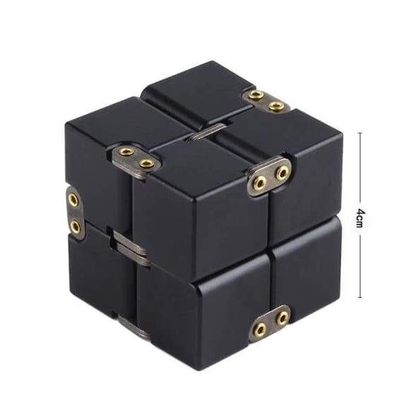Black fidget cube with gold accents on a white background.