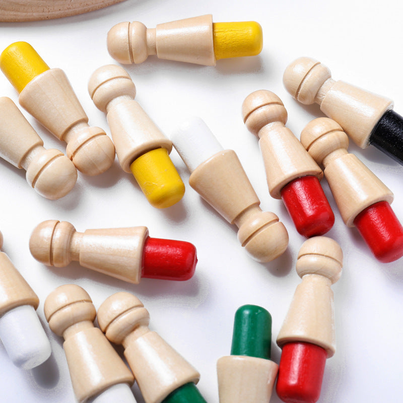 Colorful wooden chess pieces on a white surface.