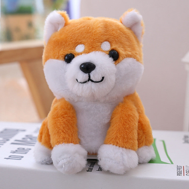 Plush toy shaped like a fox with orange and white fur on a surface.