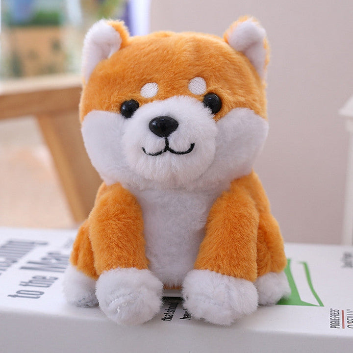 Plush toy shaped like a fox with orange and white fur on a surface.