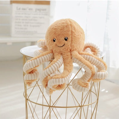 Plush octopus toy on a small round table with a blurred background.