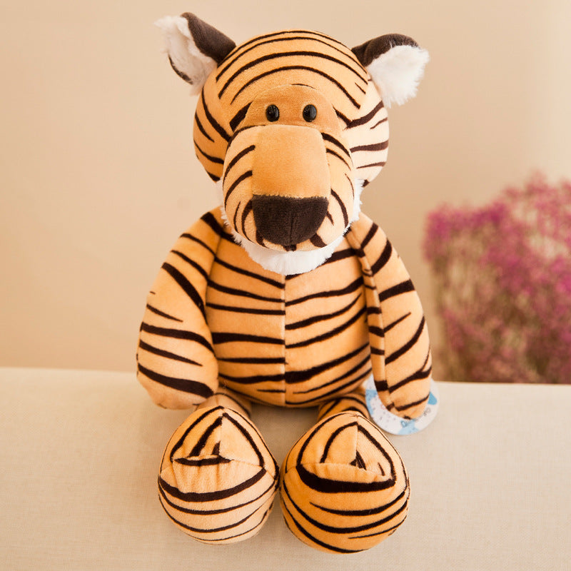 Plush tiger toy on a beige surface with a blurred floral background.