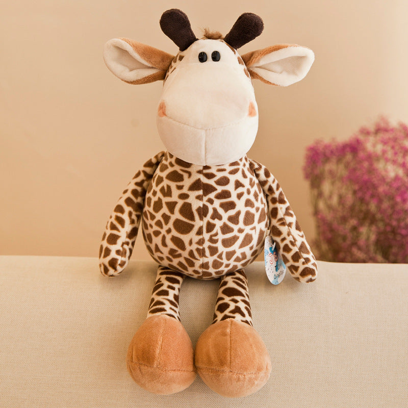 Plush giraffe toy on a beige surface with a blurred background.