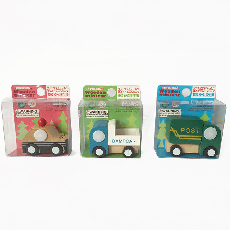Three wooden toy cars in packaging on a white background.