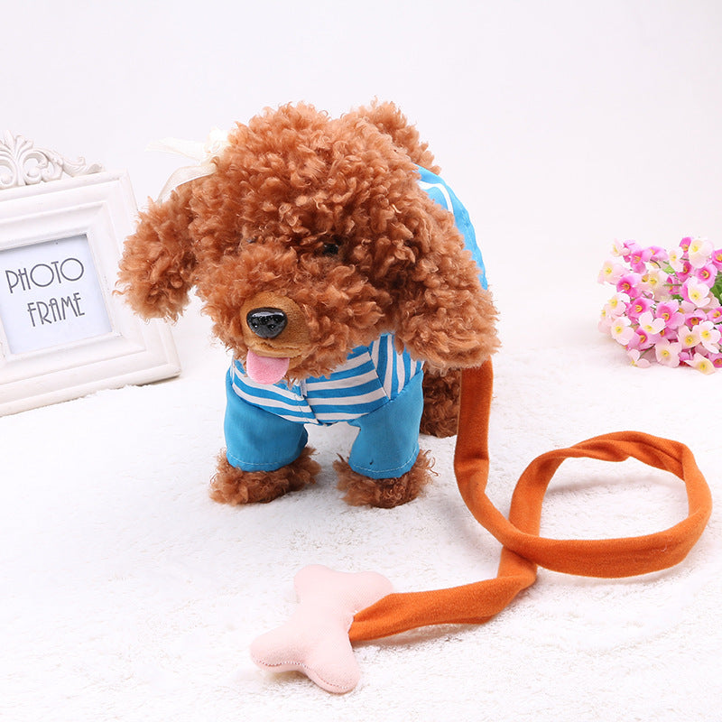Small dog wearing a blue outfit with an orange leash on a white surface.