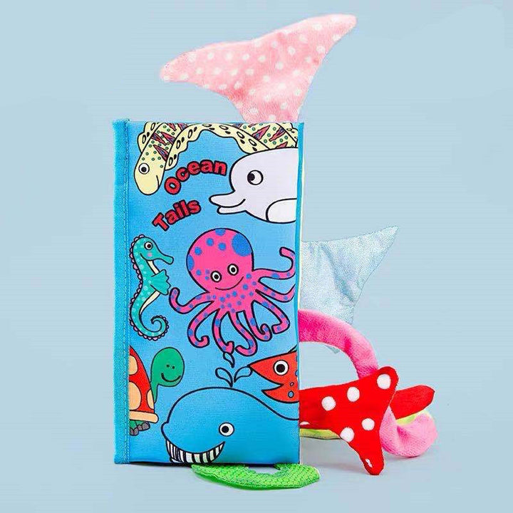 Children's book titled Ocean Tails with plush toys on a light blue background.