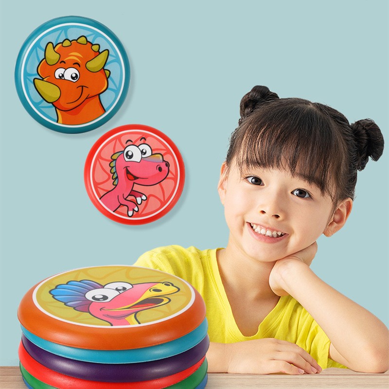 Child with colorful discs featuring cartoon characters on a light blue background.