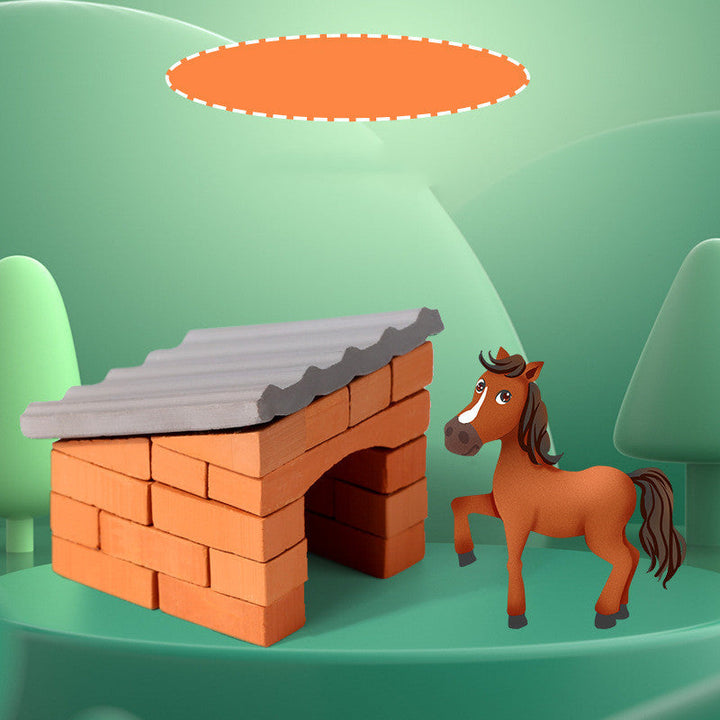 Toy horse standing next to a small brick house on a green background.