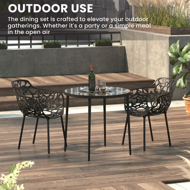 LeisureMod Devon Mid-Century Modern 3-Piece Aluminum Outdoor Patio Dining Set with Tempered Glass Top Table and 2 Stackable Flower Design Armchair Black with Background.