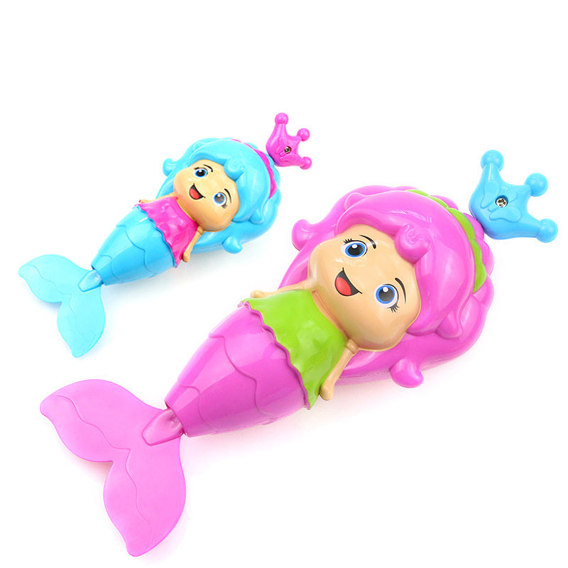 Two colorful mermaid toys with crowns on a white background.