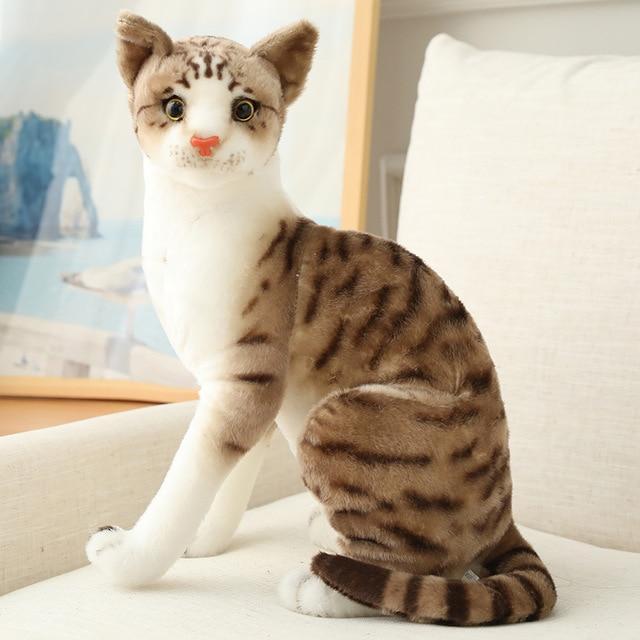 Plush toy cat with brown and white stripes sitting on a surface.