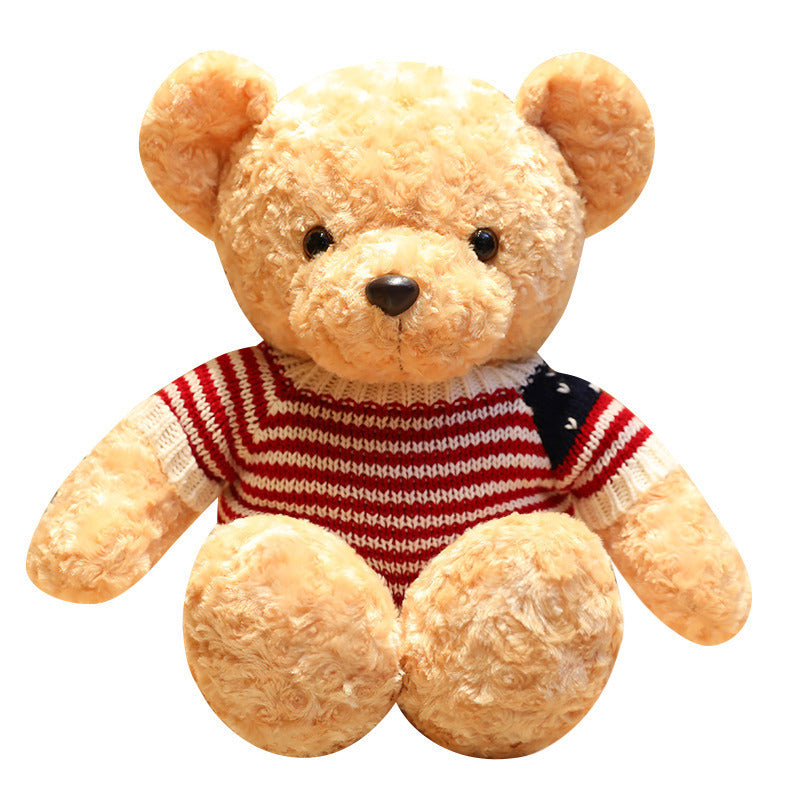 Plush teddy bear wearing a red and white striped sweater on a white background.