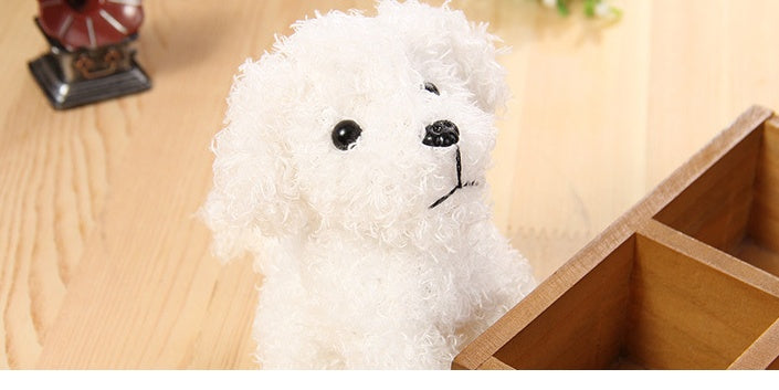 White plush dog toy on a wooden surface.