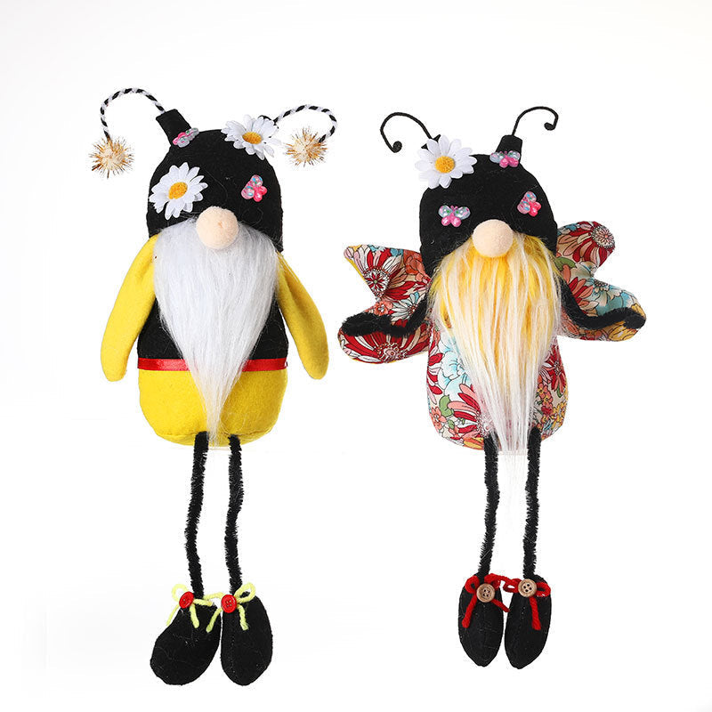 Two decorative gnomes with bee and butterfly designs on a white background.
