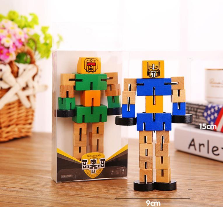 Toy building blocks in the shape of a robot with packaging on a wooden surface.