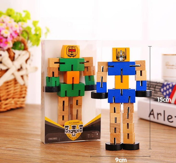 Toy building blocks in the shape of a robot with packaging on a wooden surface.