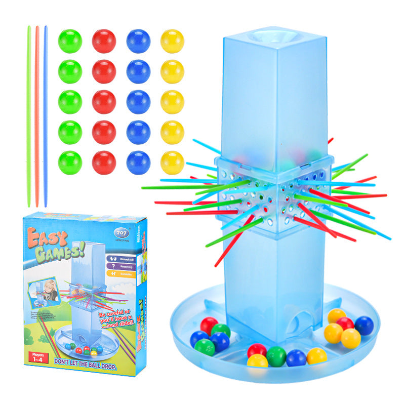 Colorful game set with balls and sticks next to its packaging on a white background.
