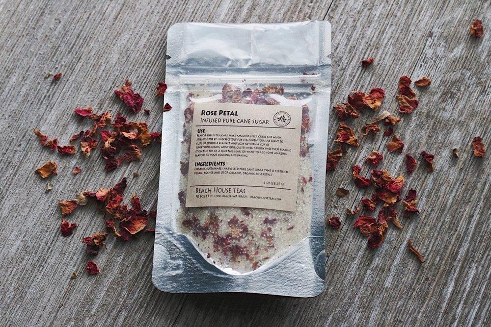 Packaged product with dried rose petals on a wooden surface.