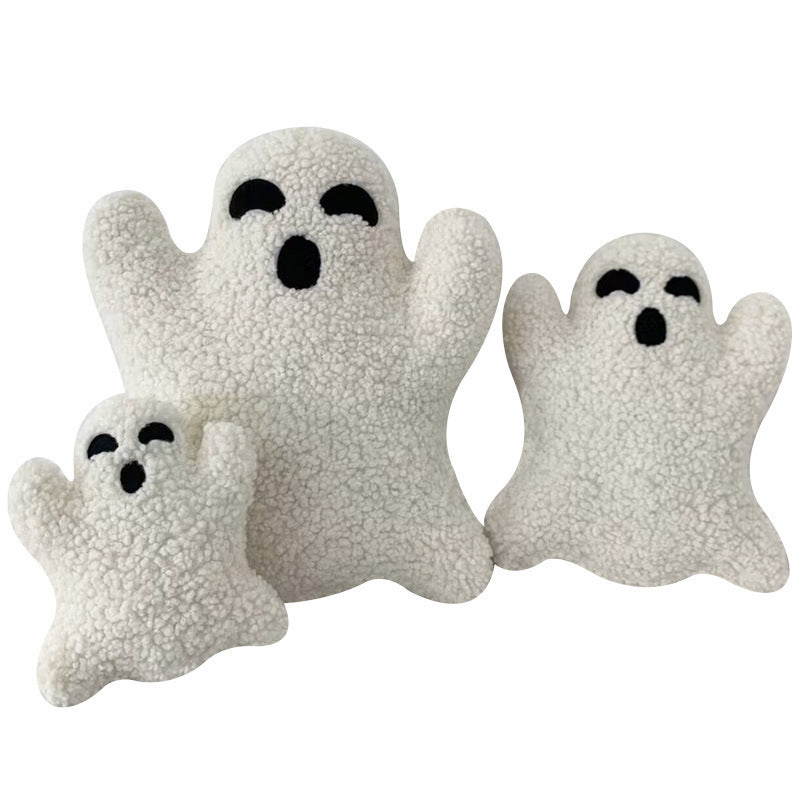 Three white ghost-shaped plush toys on a white background.