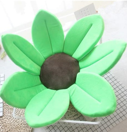 Green flower shaped cushion on a white background.