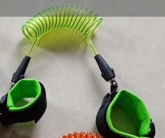 Green and black leash with green handles on a light gray background.