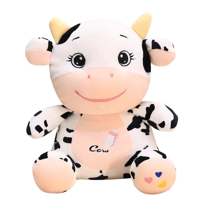 Plush cow toy with black and white pattern on a white background.