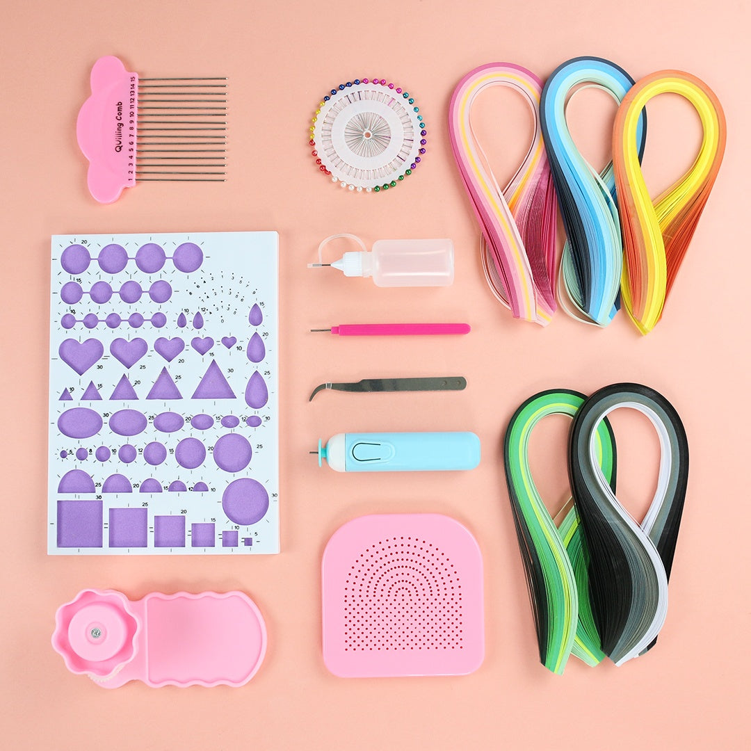 Collection of paper crafting tools including ribbons, a comb, and templates on a pink background.
