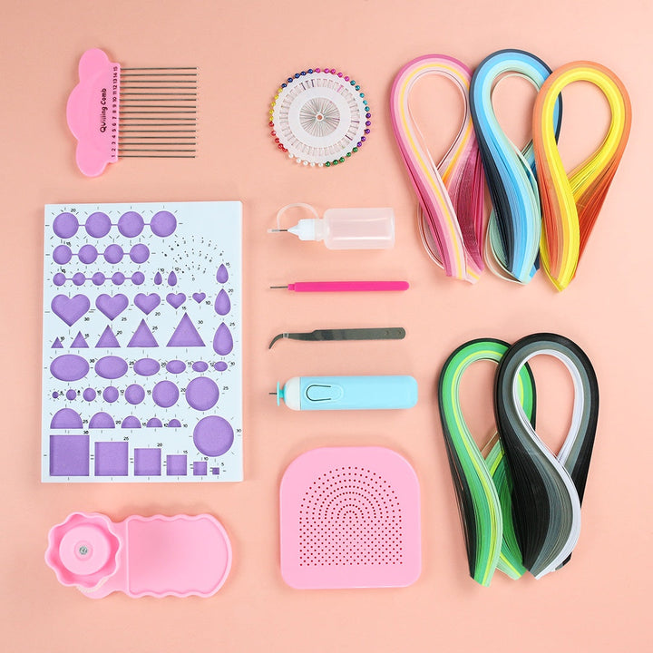 Collection of paper crafting tools including ribbons, a comb, and templates on a pink background.