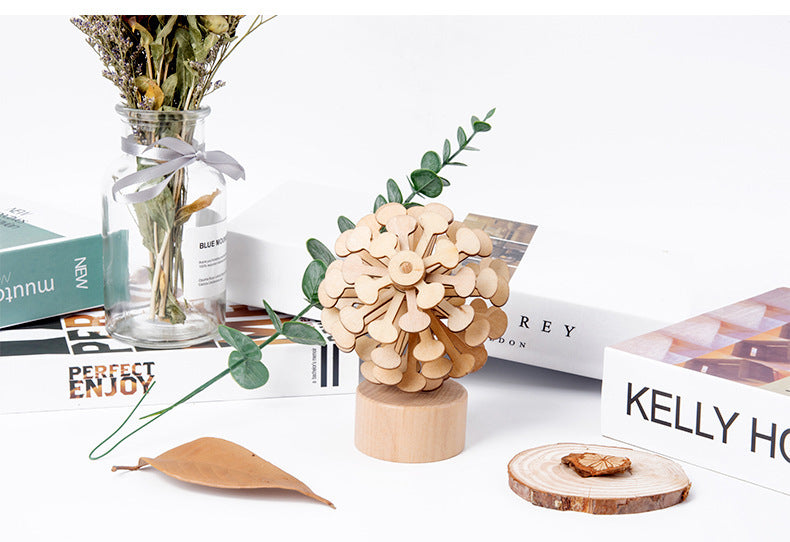 Decorative wooden item on a surface with books and a vase in the background.