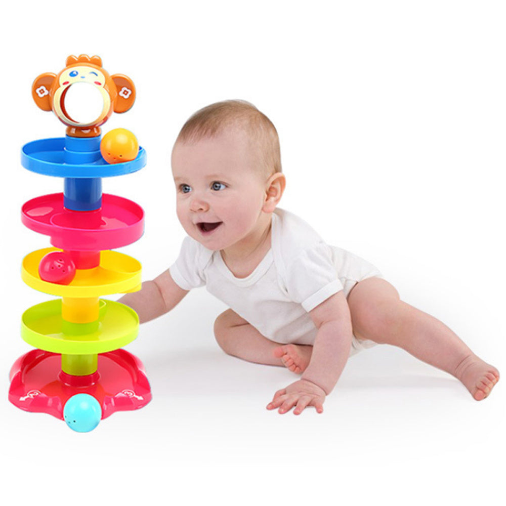Baby playing with a colorful toy on a white background.