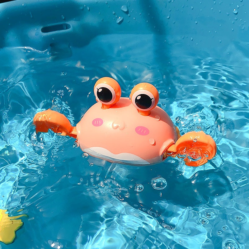 Toy crab floating in clear blue water.