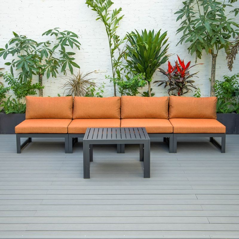 LeisureMod Chelsea 5-Piece Middle Patio Chairs and Coffee Table Set Black Aluminum with Cushions Orange on Deck.