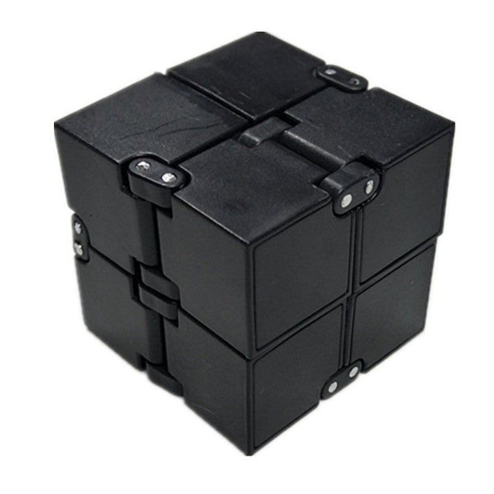 Black metal fidget cube on a white background.